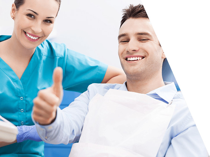 Happy patient posing with dental team member