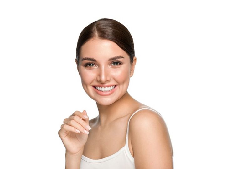 Smiling woman with perfect teeth after receiving veneers